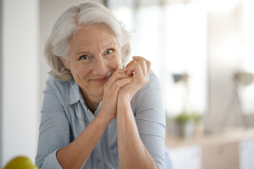 Elderly couple laughing in kitchen, sharing joyful moments with enhanced vision