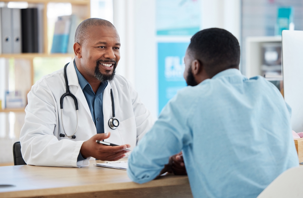 African American male doctor consulting patient in office, providing personalized eye care recommendations