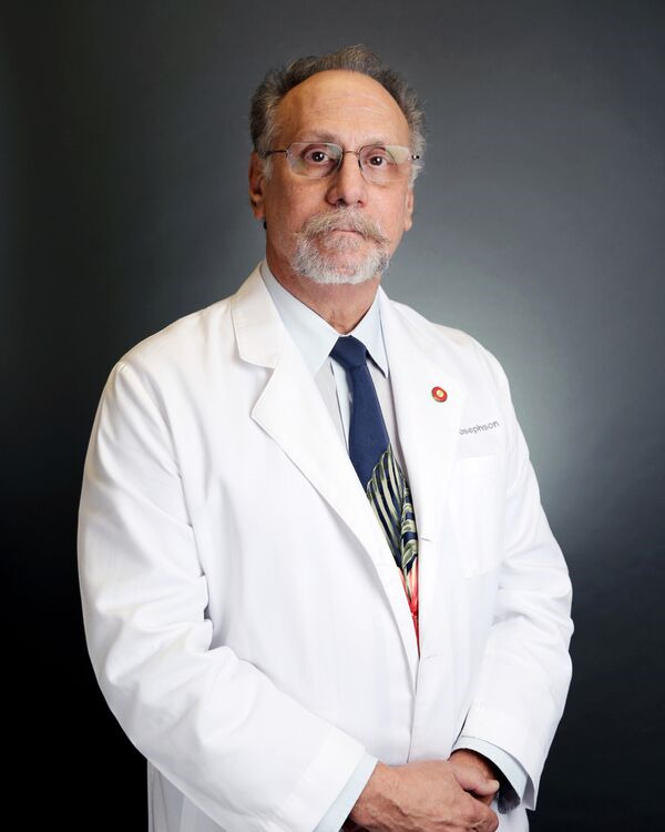 Dr. Don Josephson in a white coat. Desert Vision Center eye doctor providing comprehensive vision care.