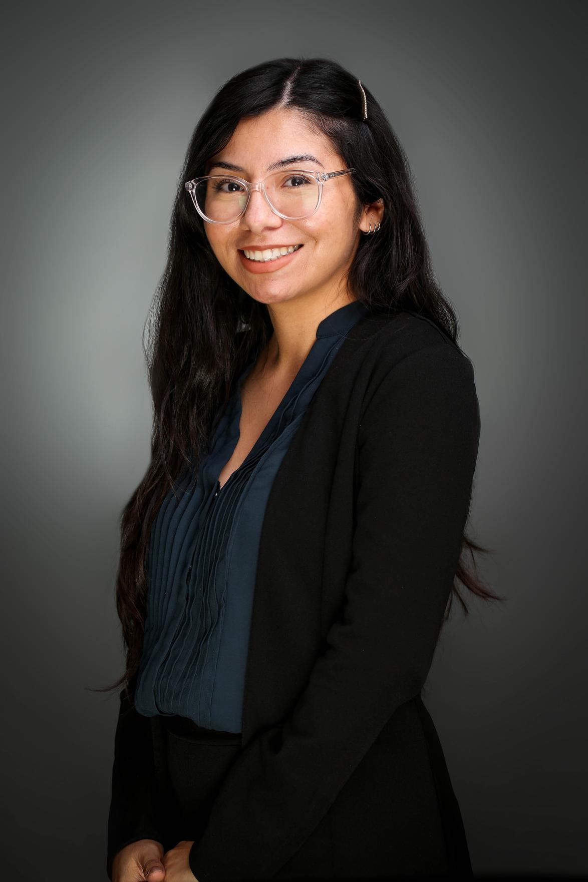 Selena smiling in glasses. Desert Vision Center staff member supporting eye exams, appointments, and patient support.