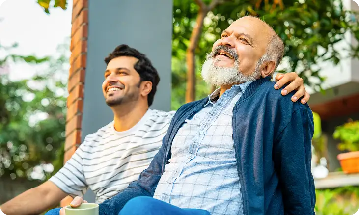 Bearded senior and son smiling outdoors – enhanced family moments via premium lenses.