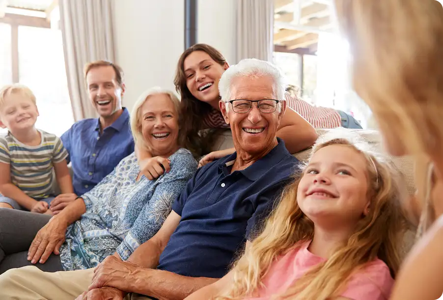 A senior man spends time with family after glaucoma treatment.