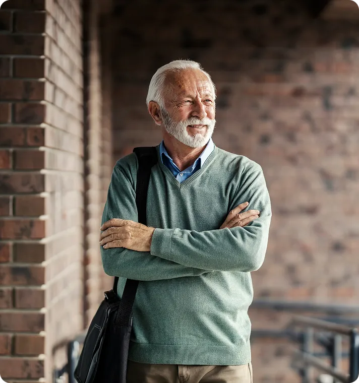 A senior man stands outside after successful secondary lens placement.